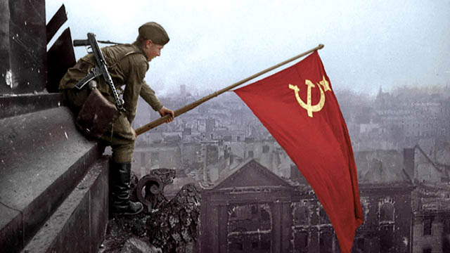 Victory Day celebration- Photo of a Red Army soldier hoisting the Soviet Union's banner atop Reichstag of Berlin after defeating Nazi Germany.